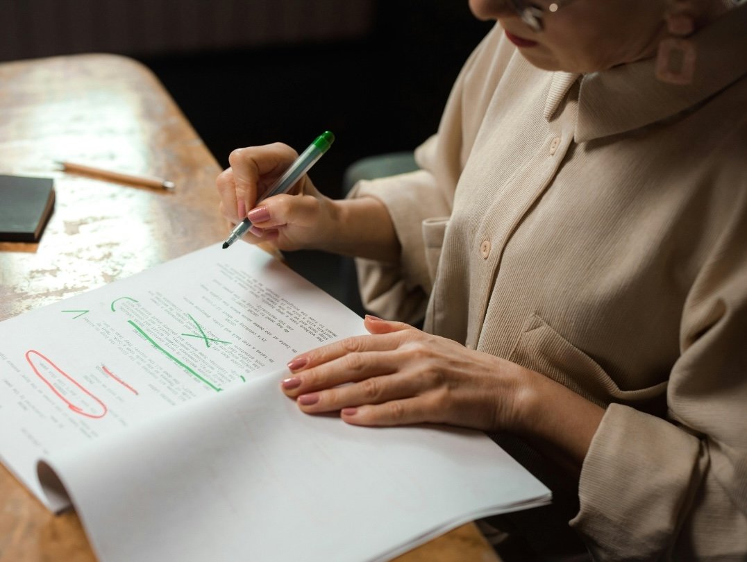 Woman grading an essay.